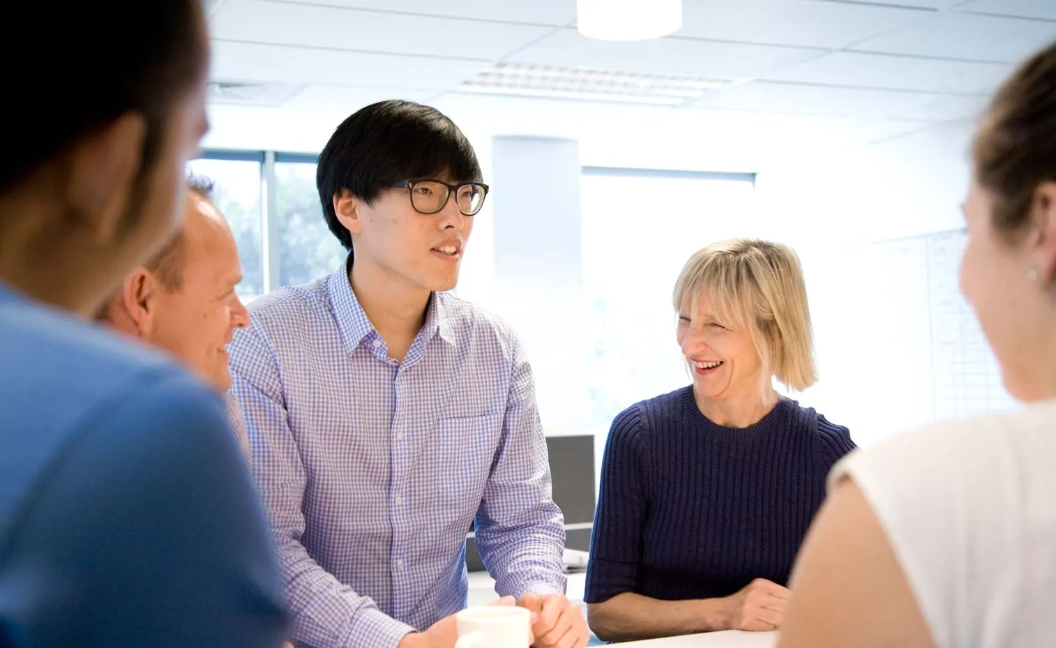 Group of staff talking and laughing