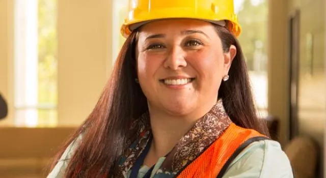 Smiling worker wearing protective gear.