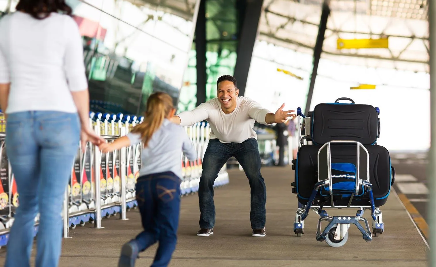 Child greeting parent at an airport