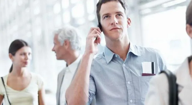 Group of people with person in front on a call.